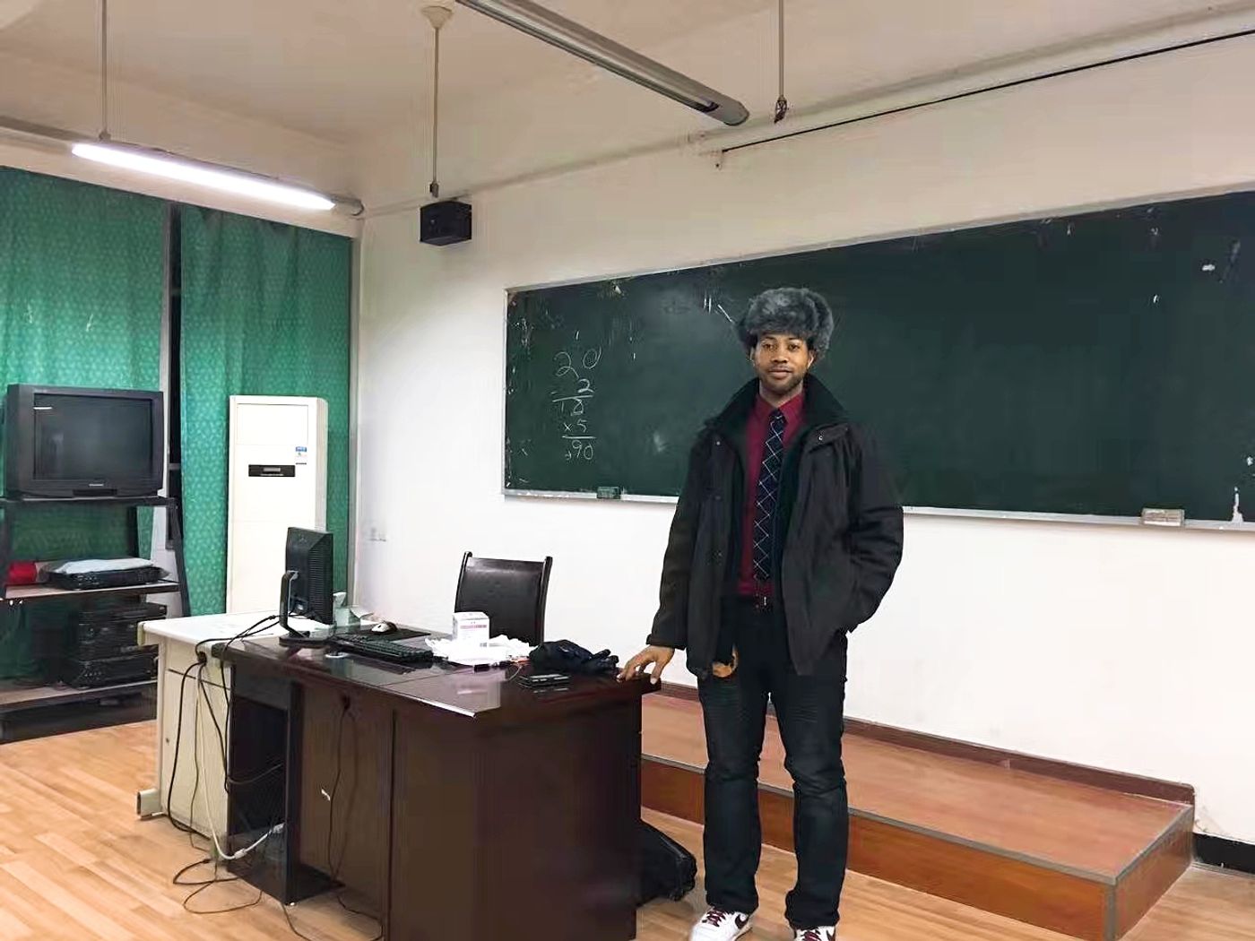 Danny Flight at the chalkboard of his classroom in China, where he taught for nearly ten years
